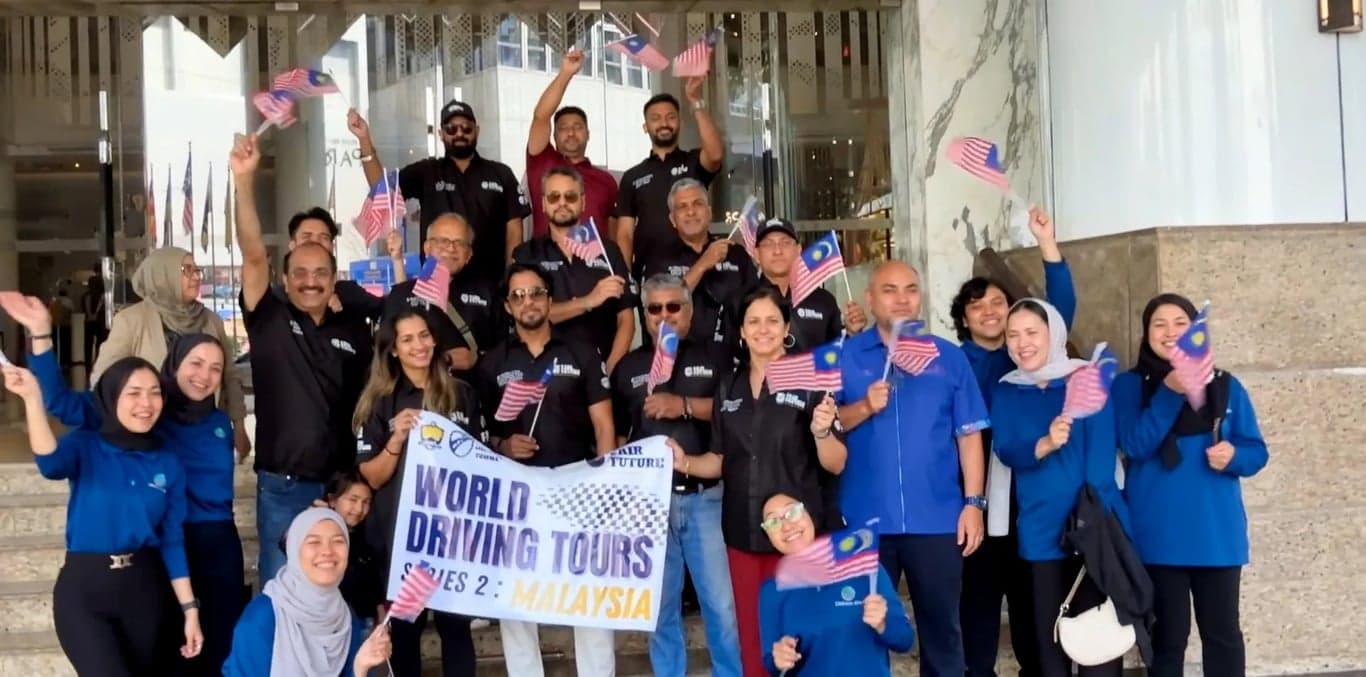 Luxury SUV driving on a mountain road at sunset